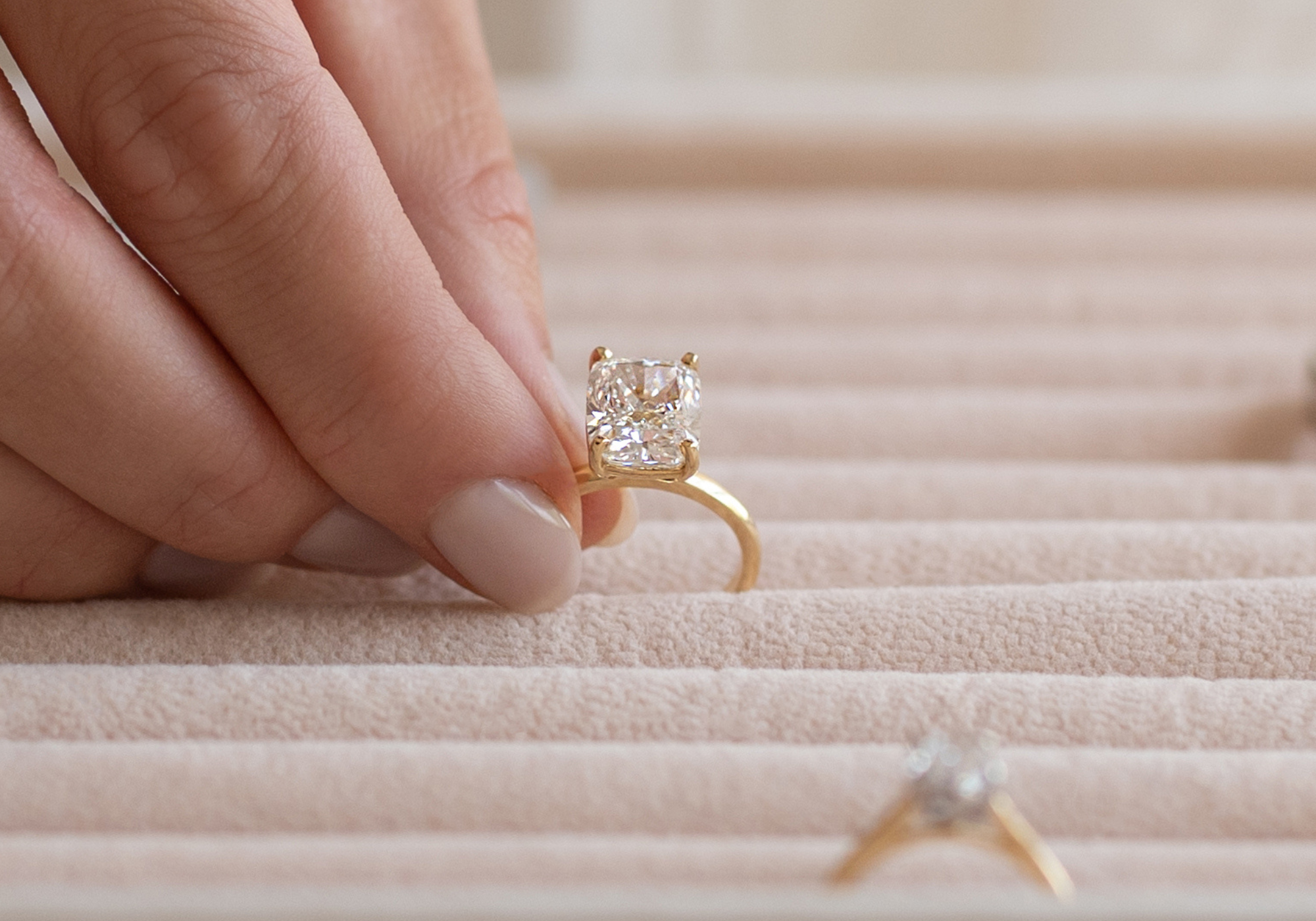Picking from a selection of solitaire gold diamond engagement rings