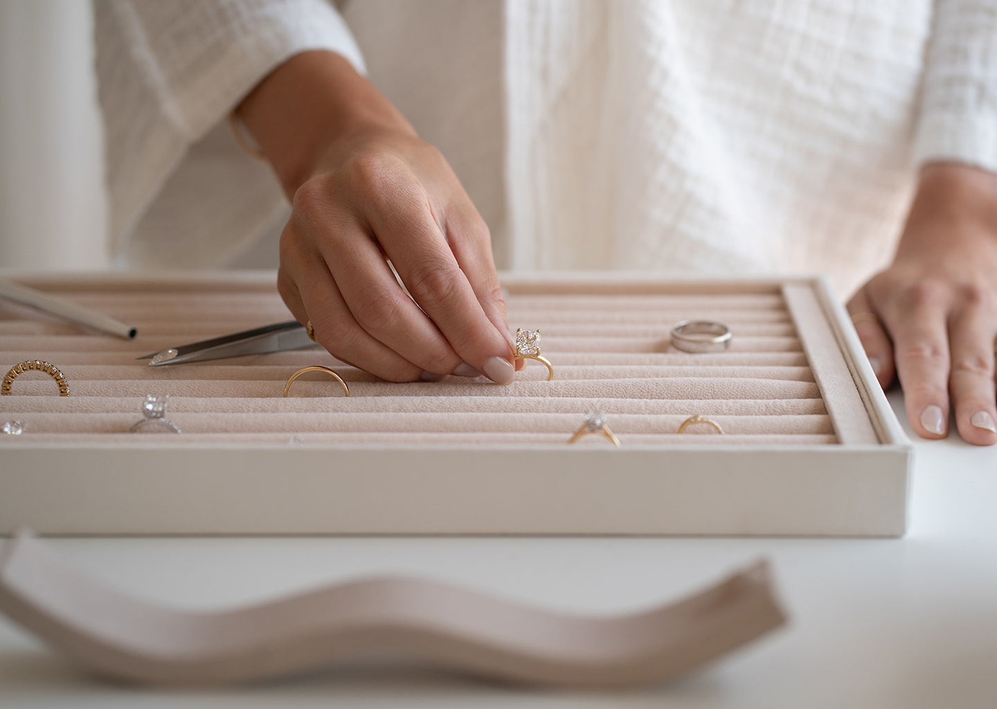 Saint Stone founders holding and showcasing their jewelry collection, featuring rings and necklaces, Australian luxury brand