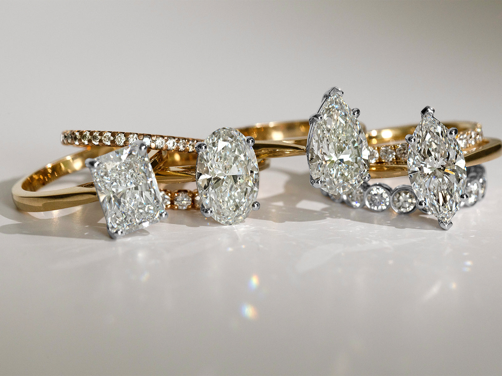 Set of Saint Stone gold and diamond rings displayed on a white surface, luxury Australian jewelry collection