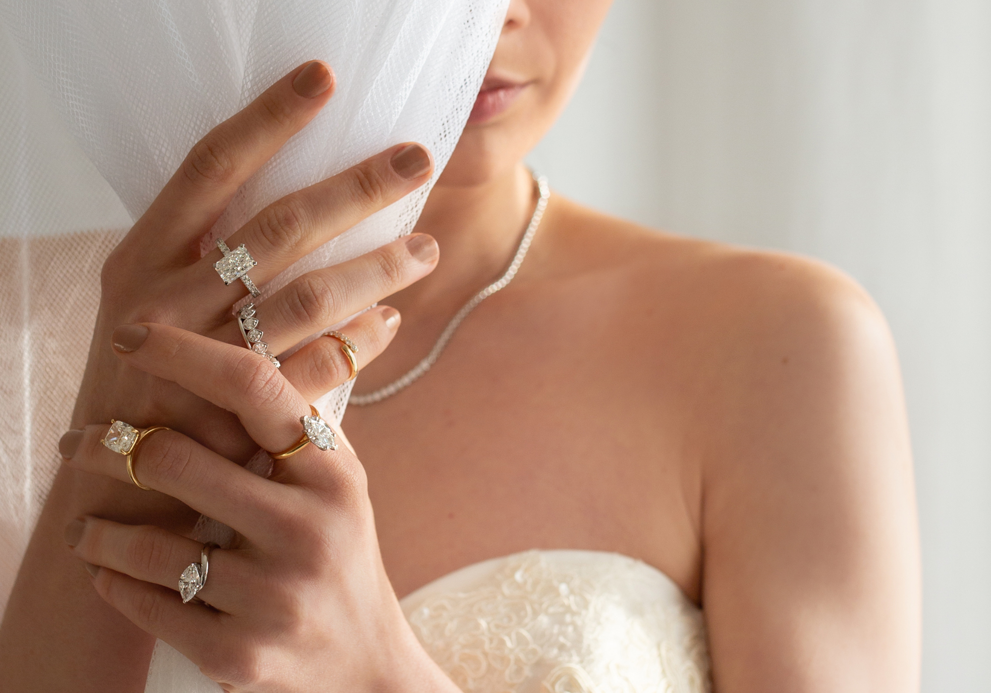 Close-up of a bride's hand with multiple diamond rings