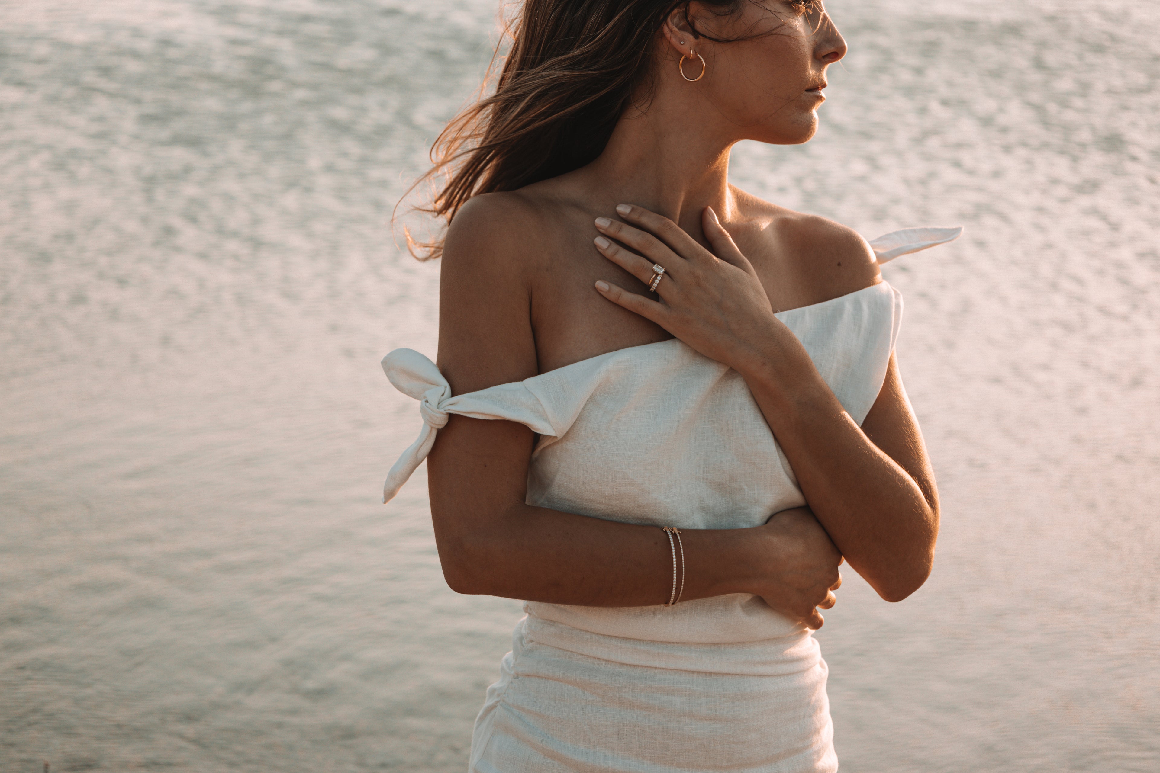 Model wearing custom jewellery including engagement ring, wedding ring, bracelets and earrings