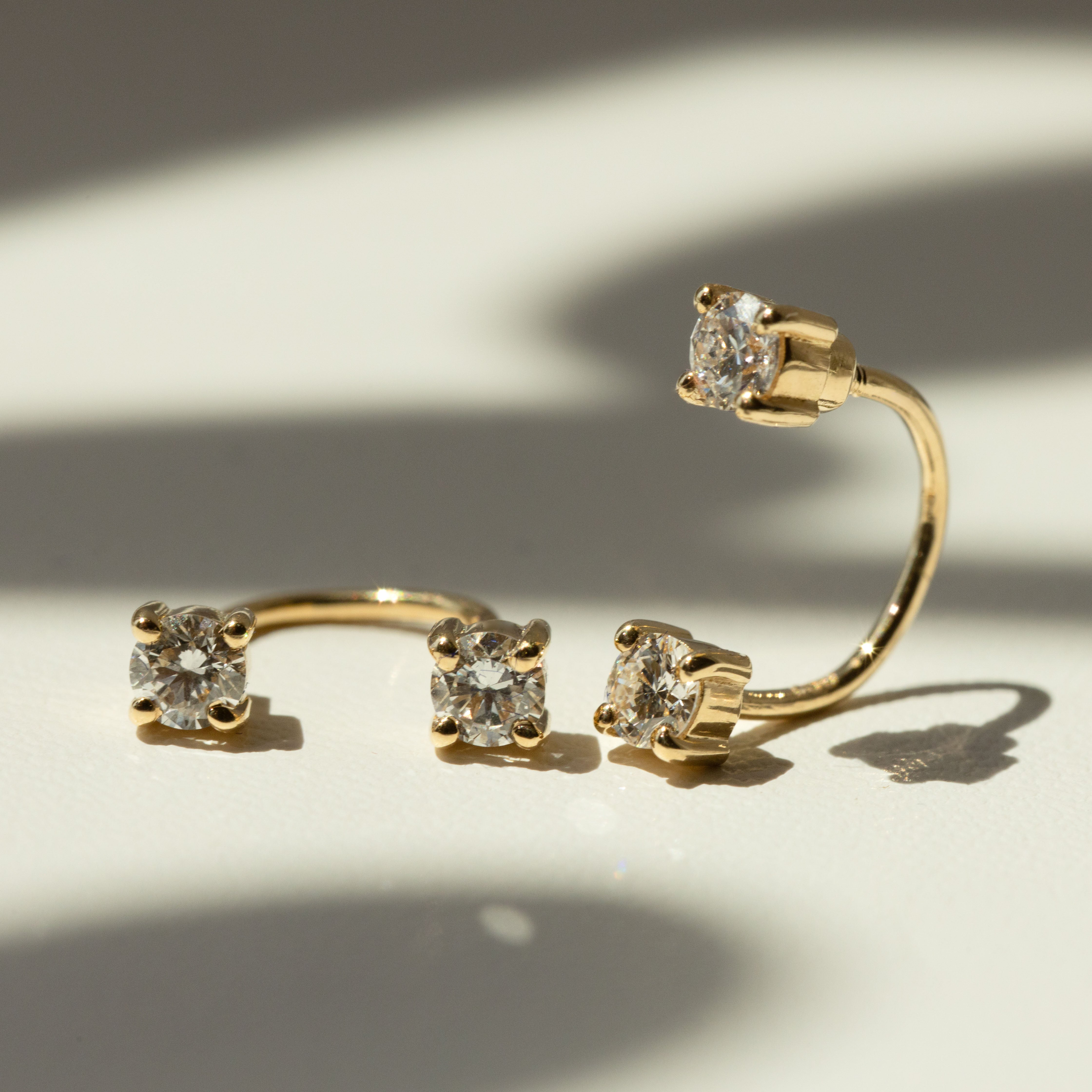 Saint Stones elegant gold earrings with clear gemstones, designed for women in Sydney, Australia. Perfect for everyday wear or special occasions, enhancing style and elegance.